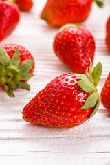 Juicy fresh strawberry on a rustic wooden background
