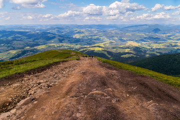 Steep descent from the mountainside against the background of a beautiful view of the surrounding...