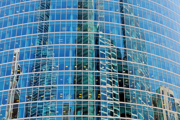 Obraz na płótnie Canvas Wall of a modern skyscraper with windows on a facade