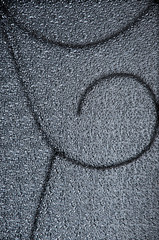 silhouette of the metal rod pattern behind the corrugated glass