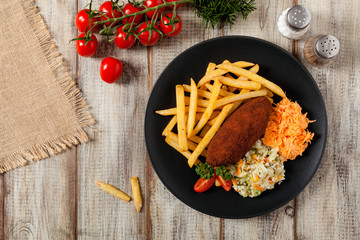 Chicken Kiev (de Volaille chop) with french fries and salads.