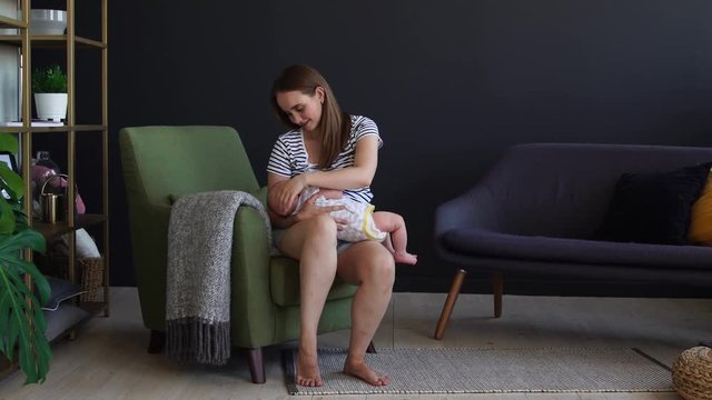 Newborn baby being breastfed by mother