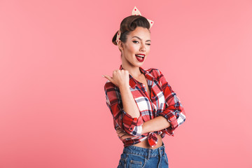 Portrait of a playful beautiful brunette pin-up woman