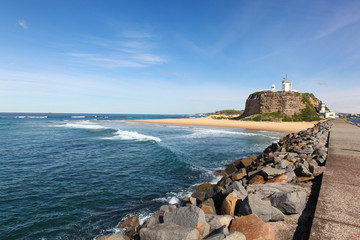Nobbys Lighthouse and beach - Newcastle Australia. This lighthouse is a famous landmark at the mouth of the Hunter River - Newcastle NSW Australia