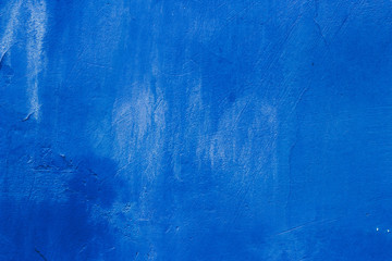 The texture of the blue wall with scratches and cracks