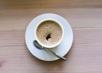 cup of coffee on wooden table. Space for text