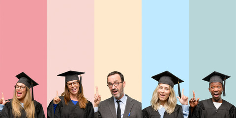 Obraz premium Senior teacher with his graduate students pointing away side with finger