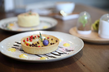 Lemon tart pie topping with chocolate ball sweet dessert on wood background