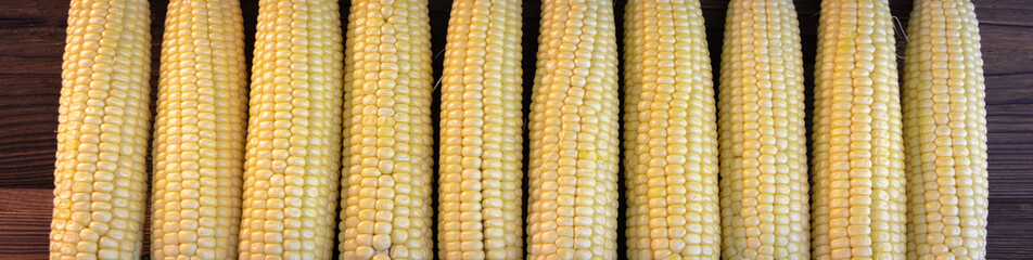 background. corn lies on a dark wooden desk