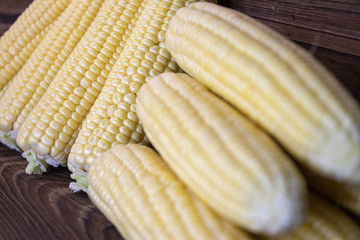 background. corn lies on a dark wooden desk