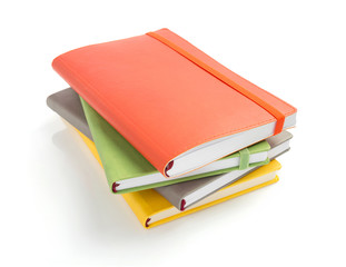 notebook and pad at white background