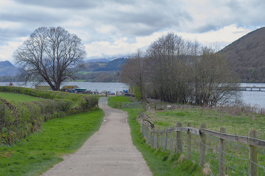 Walkway from Pooley Bridge village to the scenic lakeside of Ullswater in Lake District National Park, England, UK