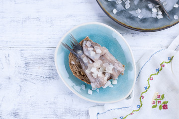 Traditional Dutch herring, with onions and toast. Fat fillets of fish. Healthy food. Healthy food. Copy space.