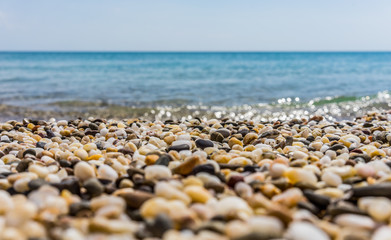 Sunny beach on the sea with sand and pebbles