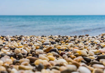 Fototapeta na wymiar Sunny beach on the sea with sand and pebbles