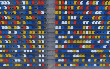 Fototapeta premium Multicolored seating in the stadium, view from the sky. Aerial photography, background.