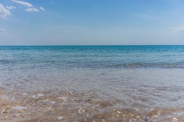 Sunny beach on the sea with sand and pebbles