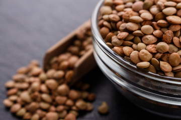 raw lentils on a dark stone background