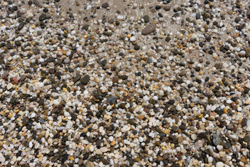 Natural background of small colored pebbles