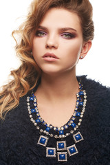 Close up portrait of a young fair-haired lady with one sided hairstyle. The girl in a navy blue...