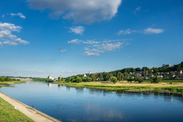 Fototapeta na wymiar Lithuania, Sky and houses reflecting in river of Kaunas