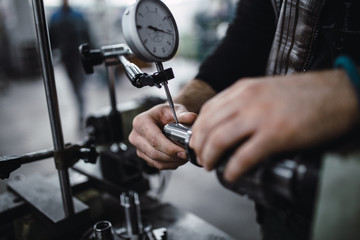 Metallurgy heavy industry. Factory for production of special industrial tools. Worker hands close up.