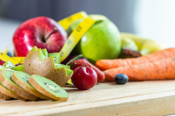 Colorful fruits are placed on many white tables. Strong fruit with vegetable salad and yellow waist line. Health Concerns.