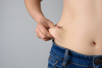 women with overweight show fat on the stomach