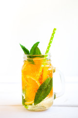 Homemade iced Fresh lemonade with mint, summer fruits and berries in a mason jar. Copy space background.