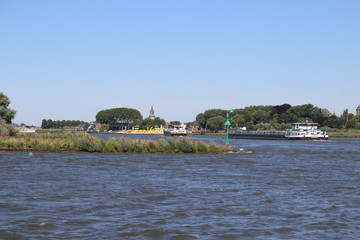 River lek, which is a lateral of river Rhine, with dykes in the sun in the Netherlands