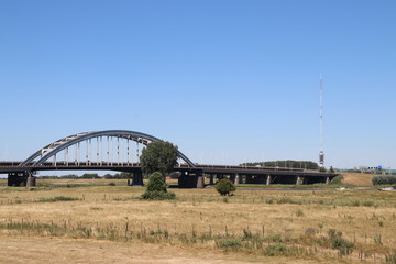 Old steel suspsension bridge over the river Lek at Vianen for highway A2 in the Netherlands.