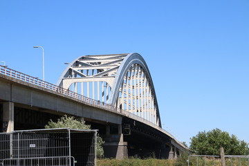 Old steel suspsension bridge over the river Lek at Vianen for highway A2 in the Netherlands.