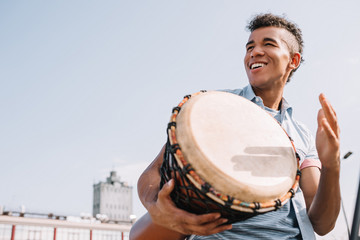 Hipster african american street drummer performing outdoors - Powered by Adobe