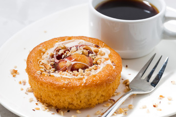 sweet pastry with cream, jam and a cup of coffee, closeup