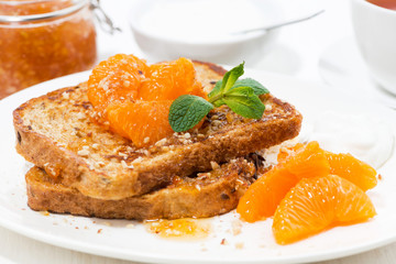 sweet french toast with jam and tangerines, closeup