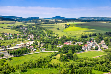 Fototapeta na wymiar Aerial view of rural landscape in mountain valley, town and houses in nature
