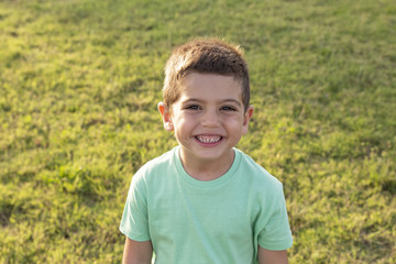 Closeup portrait of adorable sweet child on summer field