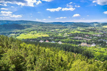 Fototapeta na wymiar Green valley, town landscape and blue sky, Sudety in Poland