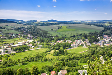 Fototapeta na wymiar Landscape of town in the valley, green scenery and blue sky, Sudety in Poland