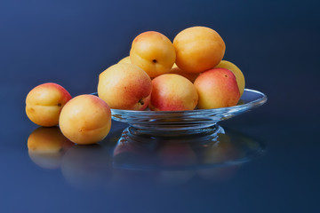 Ripe fresh apricots isolated on black background.