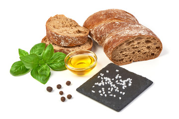 Ciabatta (Italian bread) with olive oil and basil leaf, isolated on white background.