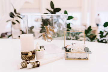 Stylish jewelry of a wedding: a boutonniere groom, a casket from metal and a candle