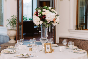 Magnificent, volume bouquets of flowers in high glass vases