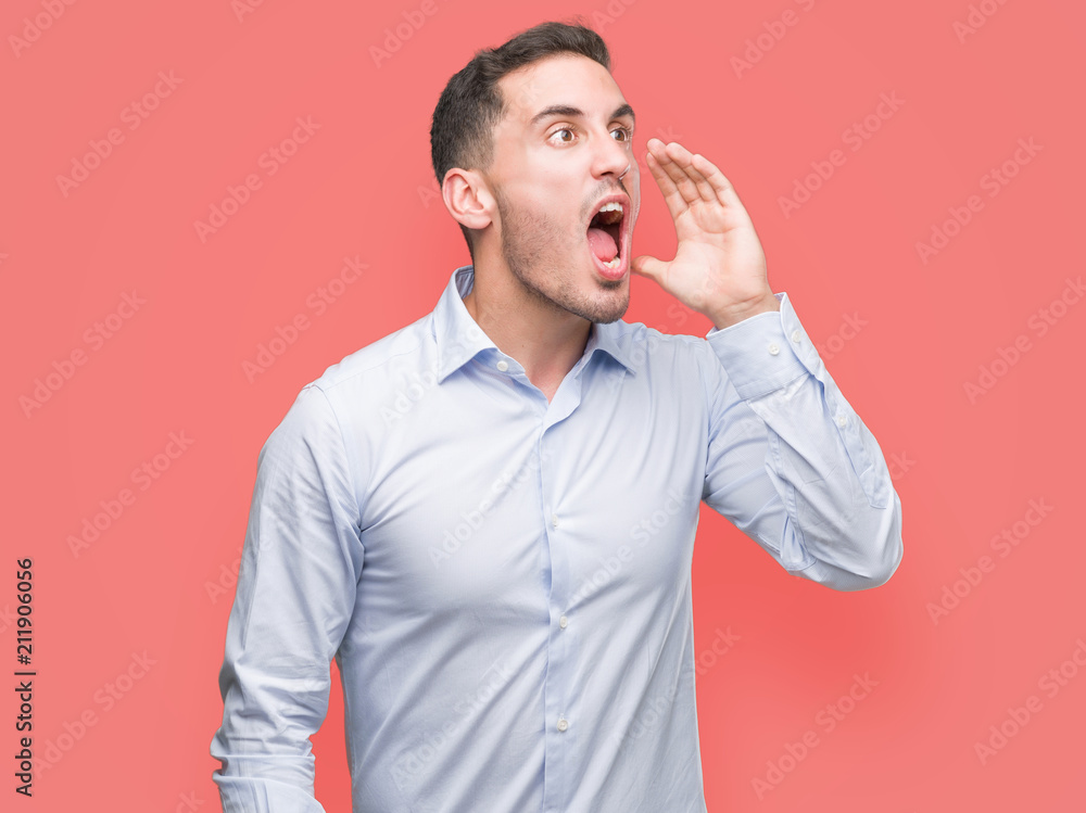 Sticker handsome young businessman shouting and screaming loud to side with hand on mouth. communication con