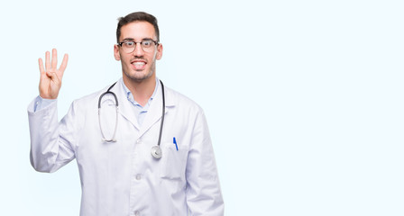 Handsome young doctor man showing and pointing up with fingers number four while smiling confident and happy.