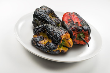 Plate with whole grilled peppers