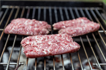 Raw Sausages cook on the grill