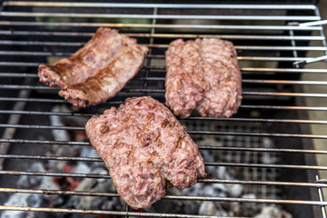 Sausages cook on the grill
