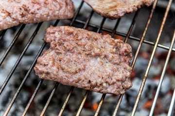 Sausages cook on the grill
