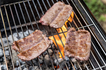 Sausages cook on the grill